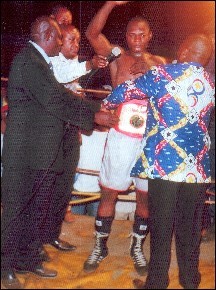 Bas Congo Minister of Sports, the Honorable Don-Andr� Phanzu-Ngom, presenting Manroy Sadic with the UBO belt.